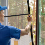 Worker,Installing,Mosquito,Net,Wire,Mesh,In,Plastic,Window,Frame