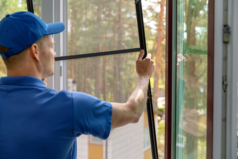 Worker,Installing,Mosquito,Net,Wire,Mesh,In,Plastic,Window,Frame